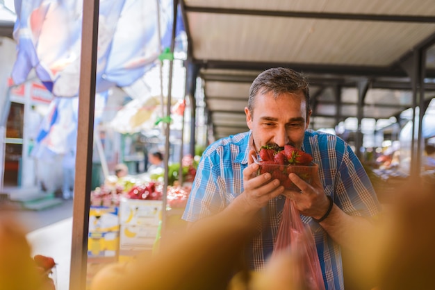 A photograph capturing a bustling local market in a small Brazilian town, with vendors selling fresh produce and shoppers using their Bolsa Família card to pay.