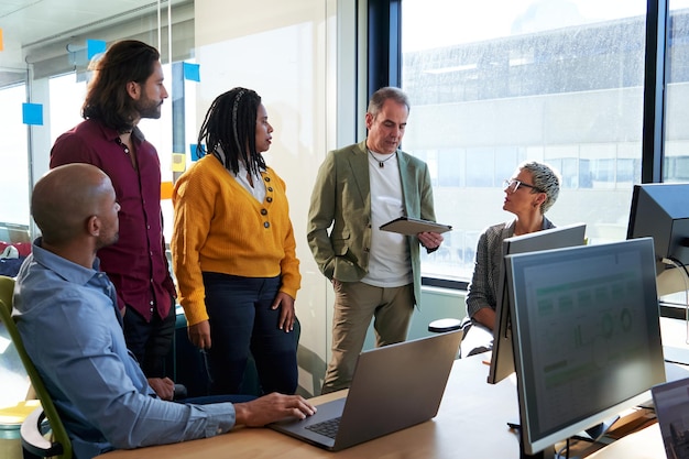 A diverse team of IT professionals collaborating on a software development project in a modern office setting, highlighting the dynamic and growing opportunities in the technology sector.