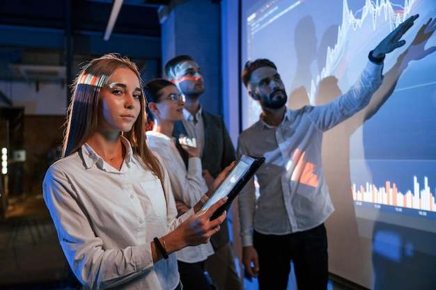 People in a high-tech conference, showcasing innovation.