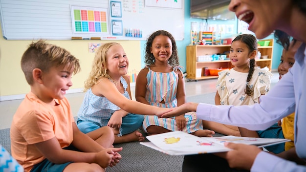 A close-up shot of a teacher engaging with a small group of children, helping them with a hands-on activity involving colorful materials and expressing encouragement and positive feedback.