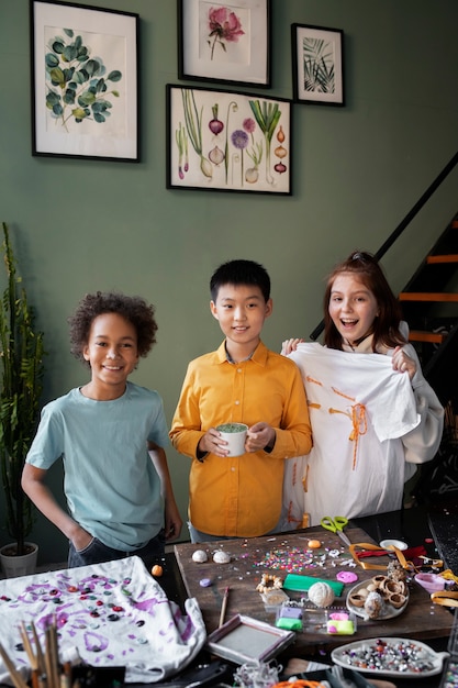 A group of diverse children working together on a collaborative art project, using various art supplies and displaying teamwork, creativity, and a sense of accomplishment.