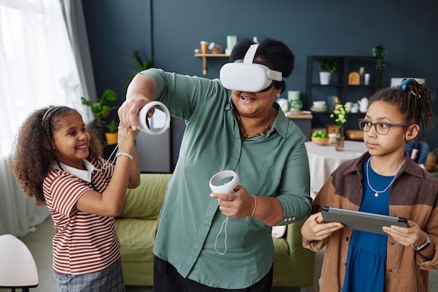 A teacher guiding a small group of students through a virtual reality learning experience, with VR headsets and smiling faces.