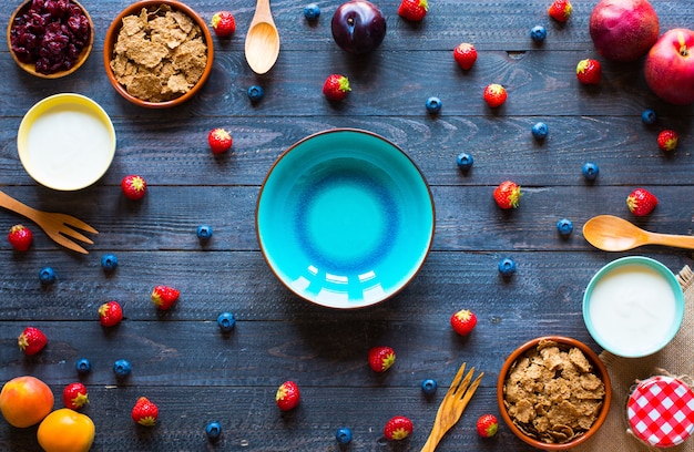 An overhead shot of a colorful breakfast setting featuring a bowl of oatmeal topped with fresh berries and nuts, a glass of freshly squeezed orange juice, and a plate with avocado toast. The setting is bright and inviting, emphasizing the freshness of the ingredients.